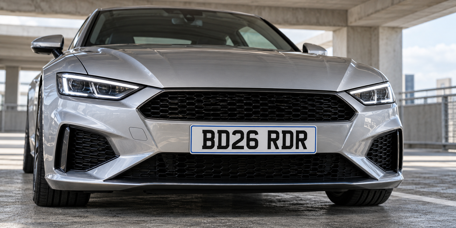 Front of a silver car with a complete white BD26 RDR number plate and slim blue border